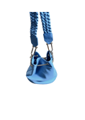 Blue dog harness with textured strap on a beige background