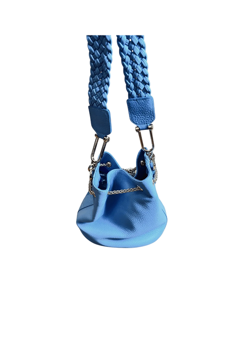 Blue dog harness with textured strap on a beige background