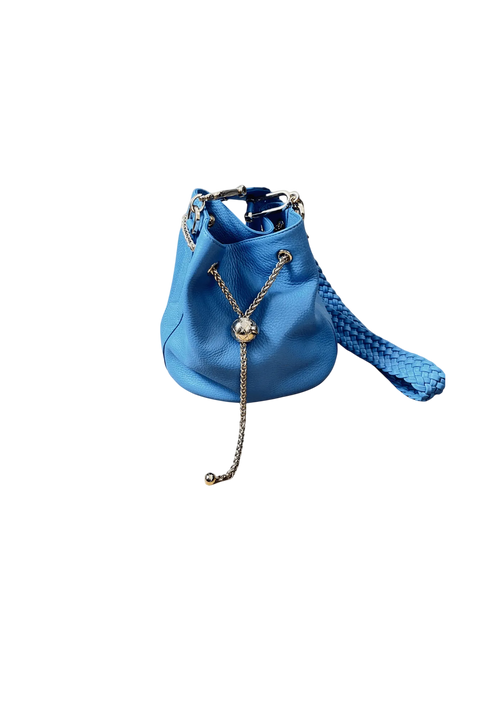 Blue leather bucket bag with a chain detail on a white background